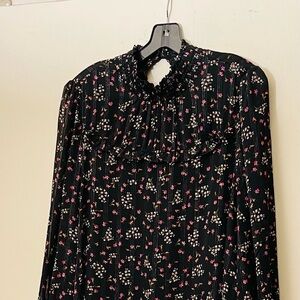 A line shaped black and pink paisley dress. Mock neck with ruffled trim.